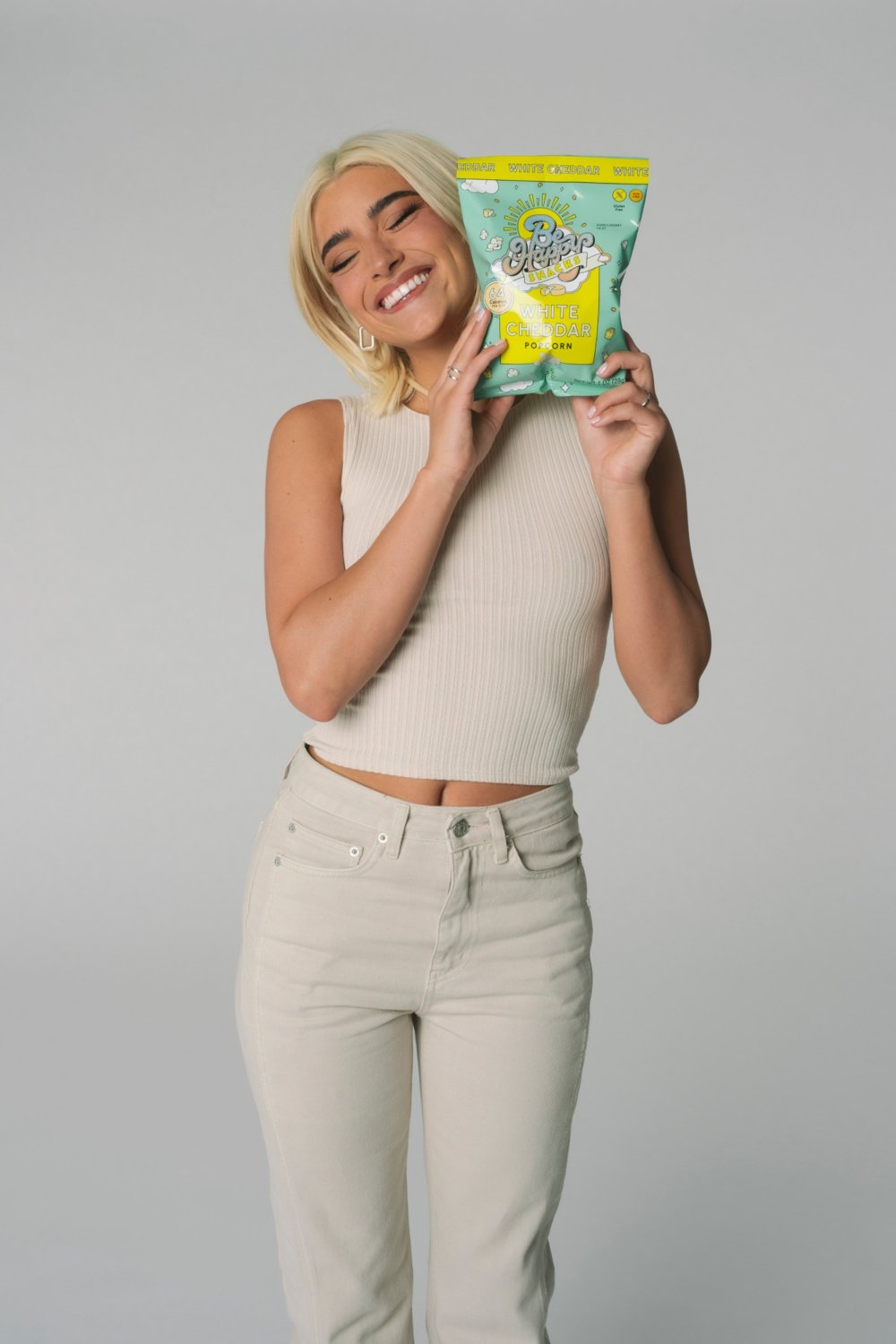 Dixie D'Amelio with Be Happy Snacks White Cheddar popcorn
