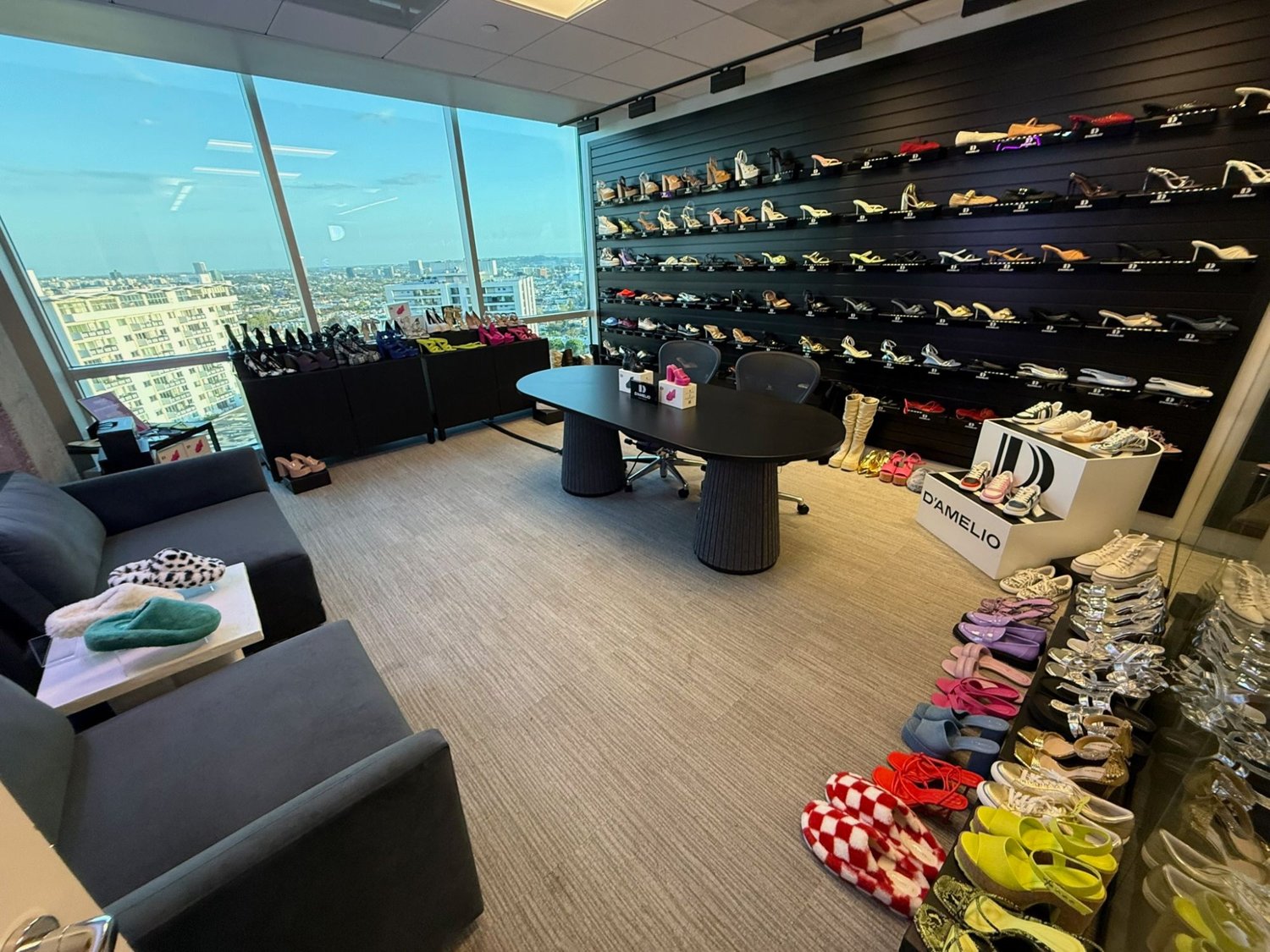 The D'Amelio Footwear showroom, sample wall and city view