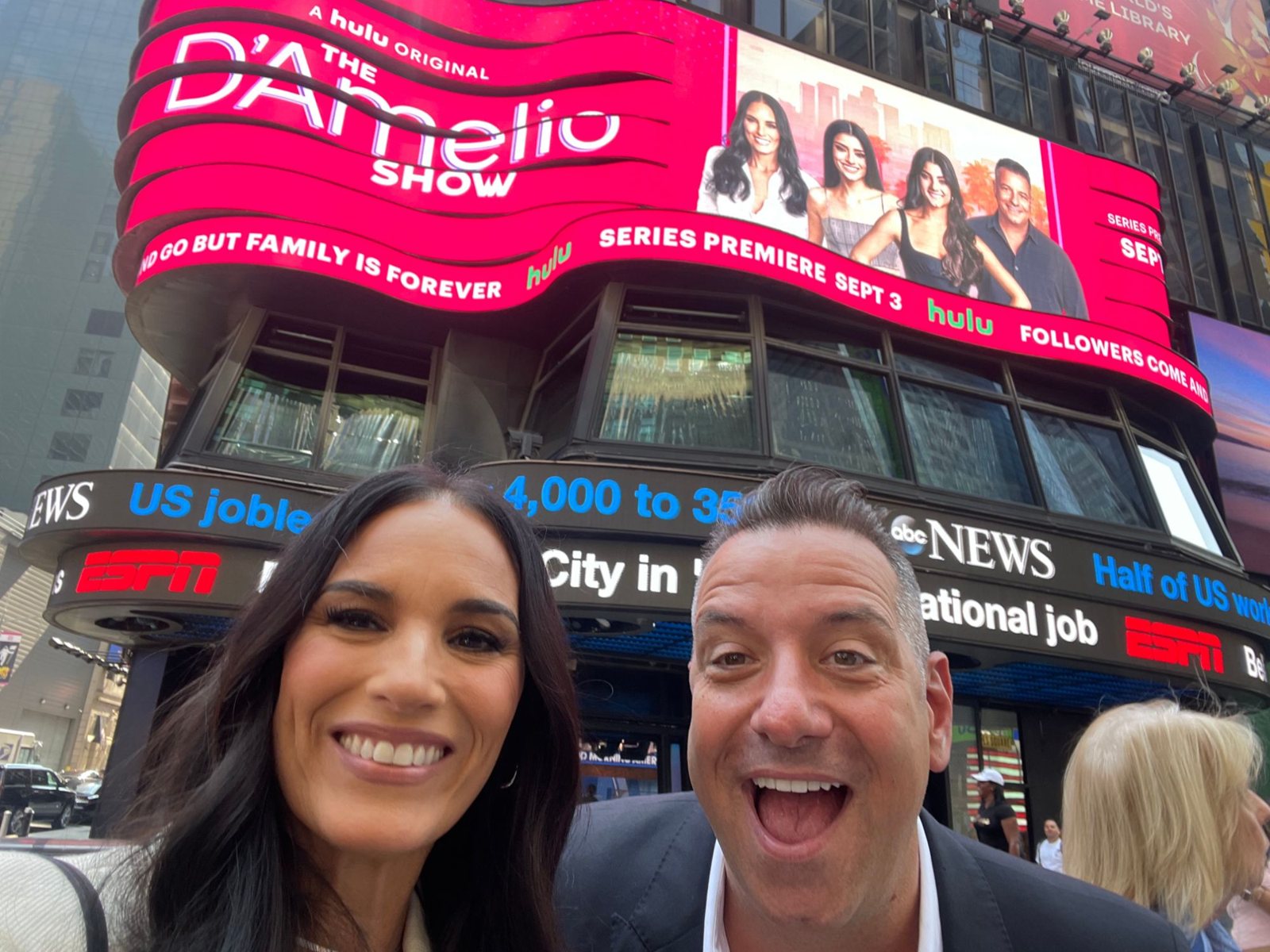 Marc and Heidi D’Amelio under The D’Amelio Show billboard in Times Square